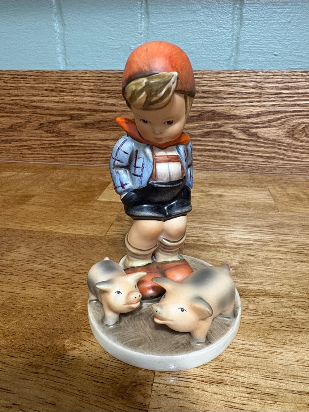 Goebel Hummel Boy with Pigs Figurine in Orange, Blue, Cream